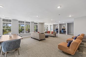 A large living room with couches and chairs and a table